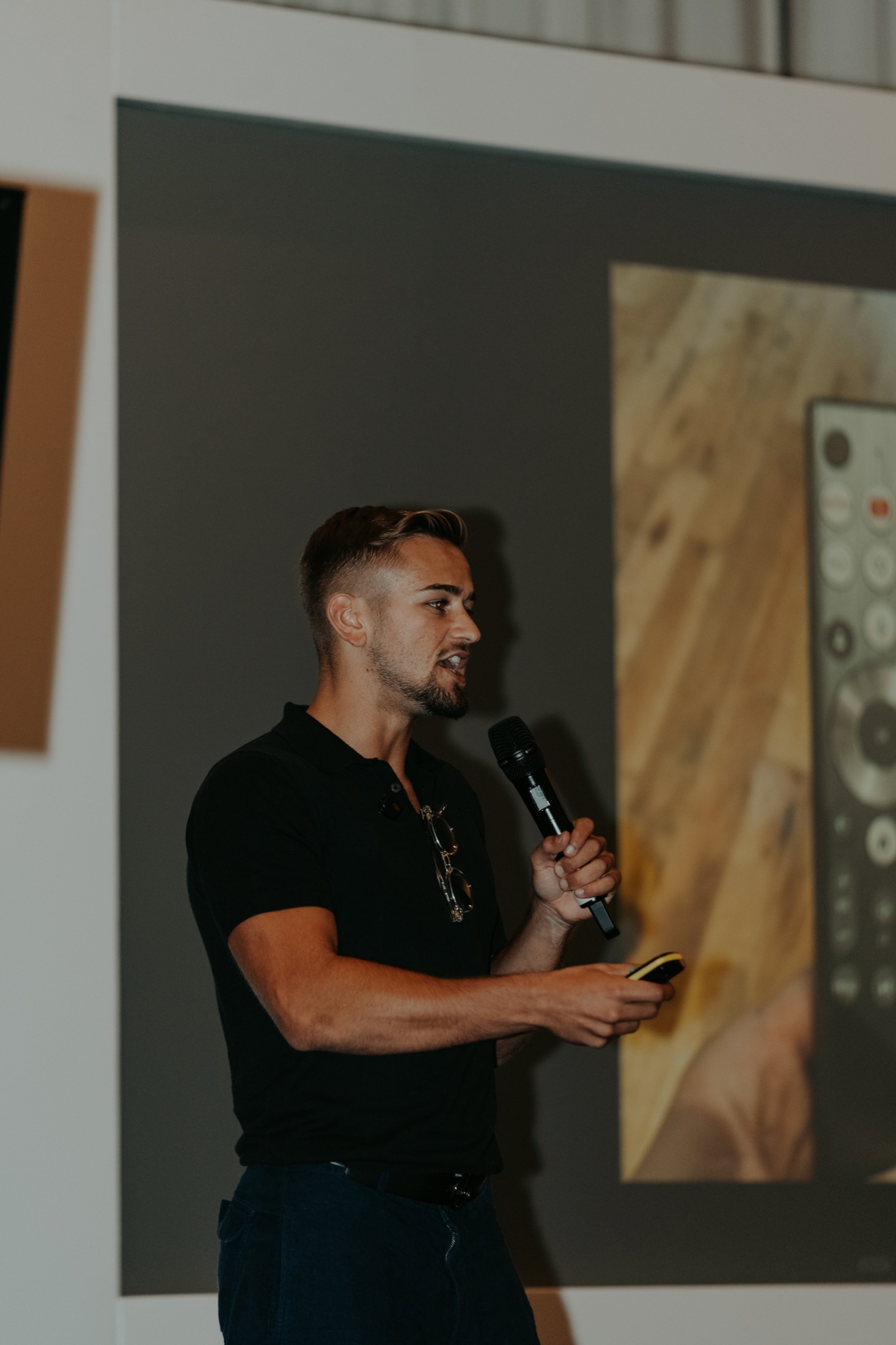 Cameron England speaking on stage